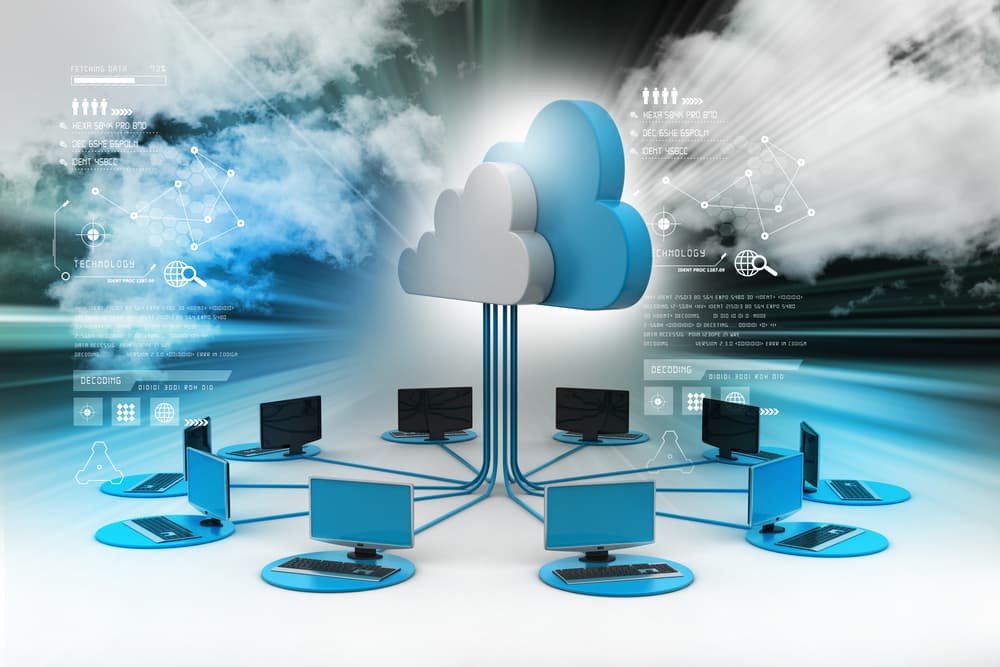 Multiple computer workstations connected to a central 3D cloud icon on a futuristic digital background.